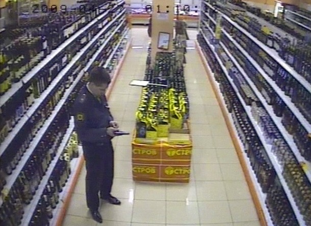 A video grab taken from surveillance camera shows Police Major Yevsyukov reloading his gun in a supermarket in Moscow